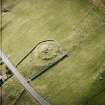Oblique aerial view centred on the remains of the broch taken, from the NNW.