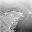 Stroma, oblique aerial view, taken from the ESE, showing Nethertown township in the centre of the photograph, and Stroma lighthouse in the centre right.