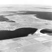 Oblique aerial view of Orkney, South Ronaldsay, Burray and South Ronaldsay, Churchill Barrier No.4 with the village of Burray taken from the S. The view N also shows the Churchill Barriers Nos.1, 2 and 3 with Lamb Holm and Glimps Holm.