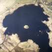 Oblique aerial view centred on the remains of the dun, taken from the SE.