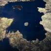 Oblique aerial view centred on the remains of the dun, taken from the E.