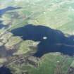 Oblique aerial view centred on the remains of the dun with the remains of the farmstead adjacent, taken from the SW.