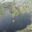 Oblique aerial view centred on the remains of the dun with the remains of the farmstead adjacent, taken from the E.