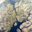 Oblique aerial view centred on the remains of the dun and the farmstead, taken from the SE.