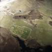 Oblique aerial view centred on the burial-ground and the remains of the church, taken from the SSE.