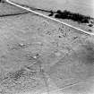Oblique aerial view of Buntait centred on the remains of hut-circles and a field-system, taken from the NW.