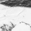 Oblique aerial view of Upperton centred on the remains of hut-circles and a field-system with cairns adjacent, taken from the SW.