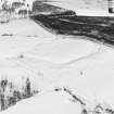 Oblique aerial view of Upperton centred on the remains of hut-circles and a field-system with cairns adjacent, taken from the S.