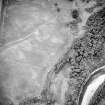 Oblique aerial view centred on the cropmarks of the ring-ditch, taken from the SSE.