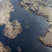 Oblique aerial view centred on the remains of the dun, taken from the NW.
