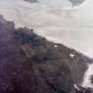 Oblique aerial view centred on the township, burial ground and remains of the buildings, taken from the N.
