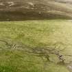 Oblique aerial view of Garbeg centred on the remains of hut-circles, buildings and a field-system, taken from the ESE.