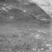 Oblique aerial view of Garbeg centred on the remains of hut-circles, buildings and a field-system, taken from the NW.