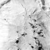 Oblique aerial view of Garbeg centred on the remains of hut-circles, a field-system, small cairns and rig, taken from the SW.