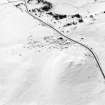 Oblique aerial view of Garbeg centred on the remains of hut-circles, a field-system, small cairns, a cairn and enclosure, taken from the NE.