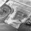 Gilchrist, oblique aerial view, taken from the SW, centred on the cropmarks of a possible enclosure and a round house.