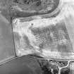Gilchrist, oblique aerial view, taken from the SE, centred on the cropmarks of a possible enclosure and a round house.