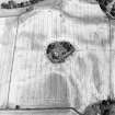 Tarradale House, oblique aerial view, taken from the SW, centred on the cropmarks of a barrow cemetery, a possible barrow and an enclosure, and on a plantation bank.