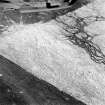 Oblique aerial view of Garbeg centred on the remains of hut-circles, buildings and a field-system, taken from the WSW.