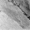 Oblique aerial view of Garbeg centred on the remains of hut-circles, buildings and a field-system, taken from the WSW.