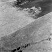 Oblique aerial view of Garbeg centred on the remains of hut-circles, buildings and a field-system, taken from the SE.