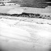 Oblique aerial view centred on the remains of the fish trap, taken from the NW.