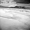 Oblique aerial view centred on the remains of the fish trap, taken from the NW.