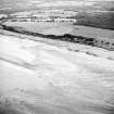 Oblique aerial view centred on the remains of the fish trap, taken from the WNW.