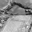Charlestown, oblique aerial view, taken from the NE, centred on the cropmarks of an enclosure and a ring-ditch.