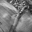 Charlestown, oblique aerial view, taken from the NE, centred on the cropmarks of an enclosure.