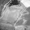 Oblique aerial view centred on the cropmarks of the possible quarries, pit-setting and rig, taken from the ENE.