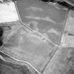 Oblique aerial view centred on the cropmarks of the possible quarries, pit-setting and rig with cropmarks adjacent, taken from the SE.