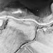 Ferryton Point, oblique aerial view, taken from the SSE, centred on the cropmark of a ring-ditch. Ferryton Storehouse is visible in the center right half of the photograph.