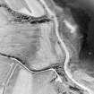 Ferryton Point, oblique aerial view, taken from the E, centred on the cropmark of a ring-ditch. Ferryton Storehouse is visible in the bottom right-hand corner of the photograph.