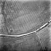 Oblique aerial view centred on the cropmarks of the palisaded enclosure, taken from the WSW.