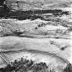 Ballourie, oblique aerial view, taken from the SE, showing the remains of a township across the photograph, and rig in the foreground.