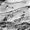 Ballourie, oblique aerial view, taken from the N, showing the remains of a township across the photograph, and rig in the top half.