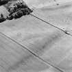 Oblique aerial view centred on the cropmarks of the unenclosed settlement with Budgate House adjacent, taken from the NNE.