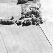 Oblique aerial view centred on the cropmarks of the unenclosed settlement with Budgate House adjacent, taken from the NNW.