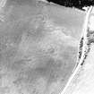 Pityoulish, oblique aerial view, taken from the NE, centred on the cropmarks of a round house, pits and a possible souterrain.