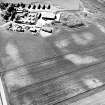 Mains of Gartan, oblique aerial view taken from the E, centred on the remains of a motte and the cropmark of a possible enclosure.  The Mains of Garten is visible in the top left hand corner of the photograph.