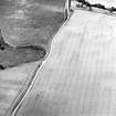 Oblique aerial view centred on the cropmarks of the possible barrow and pits, taken from the NNE.