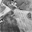 Meadowfield, oblique aerial view, taken from the W, centred on the cropmarks of two plantation banks. Meadowfield farm is visible in the top centre half of the photograph.