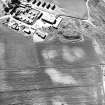 Mains of Gartan, oblique aerial view taken from the ESE, centred on the remains of a motte and the cropmark of a possible enclosure.  The Mains of Garten is visible in the top left hand corner of the photograph.