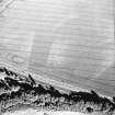 Pilmuir, oblique aerial view, taken from the NW, centred on the cropmarks of a barrow cemetery.