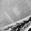 Pilmuir, oblique aerial view, taken from the N, centred on the cropmarks of a barrow cemetery.