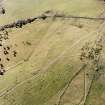 Oblique aerial view of Lynardoch centred on the remains of farmsteads surrounded by cultivation remains, taken from the E.