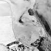Oblique aerial view of Peel of Fichlie centred on the remains of a motte-and-bailey castle, taken from the W.