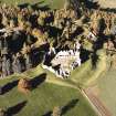 Oblique aerial view of Kildrummy castle centred on the remains of the castle, taken from the SE.