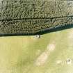 Oblique aerial view centred on the remain of the cairn taken from the SSE.